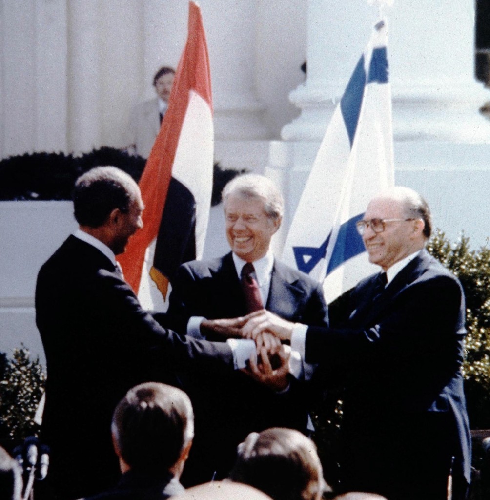 Menachem Begin, Jimmy Carter and Anwar Sadat triple-shake hands in 1979 to symbolize the first partnership between Israel, Egypt and the US. Today, is that relationship only getting stronger, and if so, why now? (Government Press Office/Wikimedia Commons)