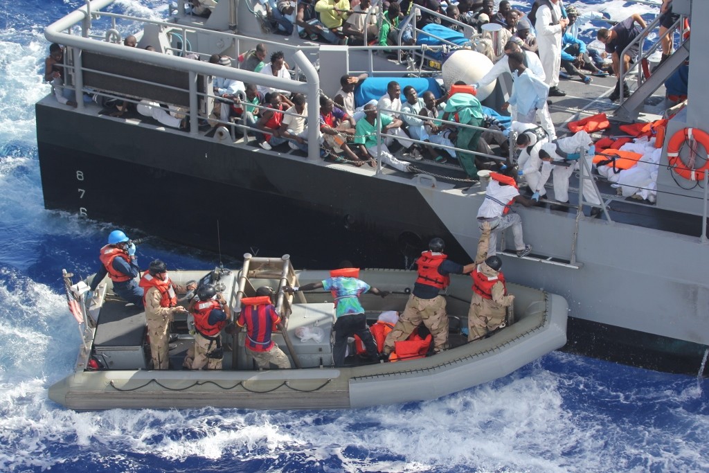Distressed refugees rescued and transferred to Maltese patrol vessel. October 17, 2013. (Wikimedia Commons/US Navy) 