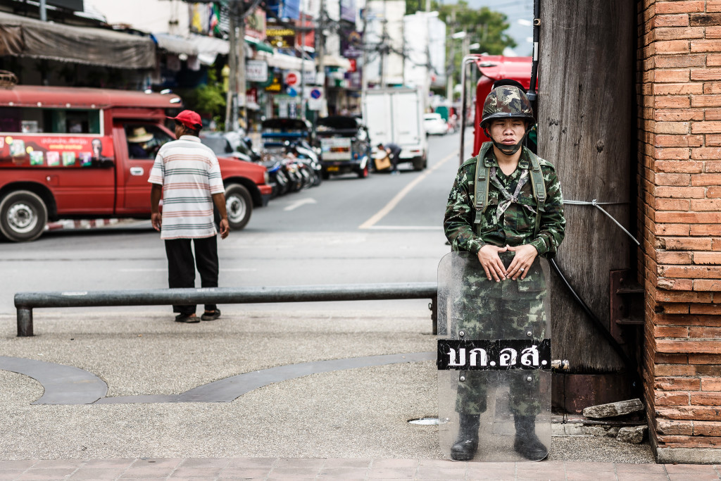 A soldier stands guard on a street corner in Bangkok in June 2014, a month after Thailand’s most recent military coup (Tore Bustad, Flickr Creative Commons).