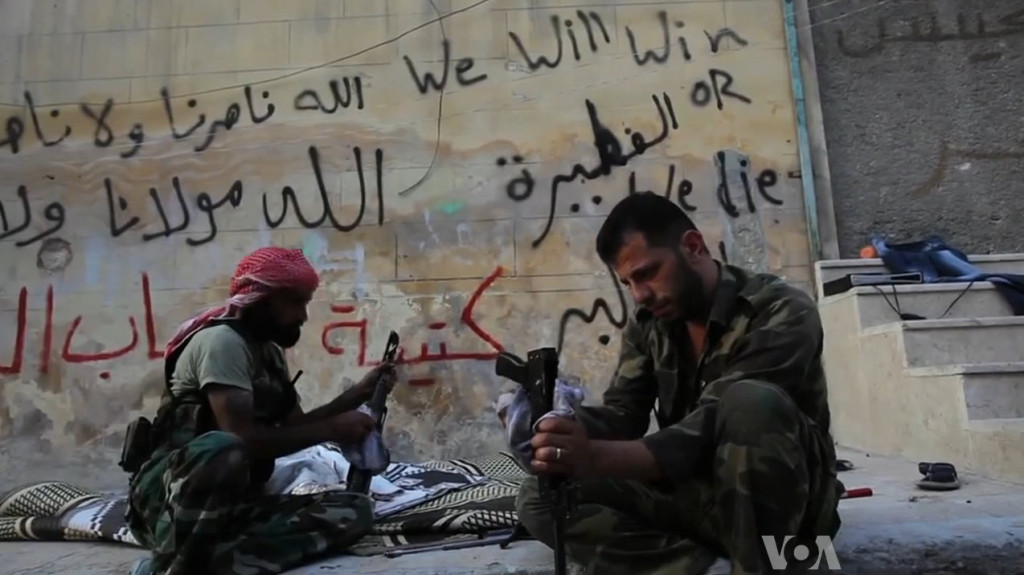 FSA rebels cleaning their AK47s in Aleppo, Syria during the civil war (19 October 2012). (VOA News/Wikimedia Commons)