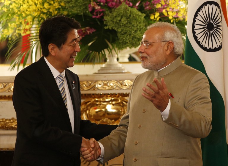 India's Prime Minister, Narendra Modi (right), and Japan's Prime Minister, Shinzo Abe, shake hands before their talks at the state guesthouse in Tokyo. 2014. (Scroll Editorial/Flickr Creative Commons)