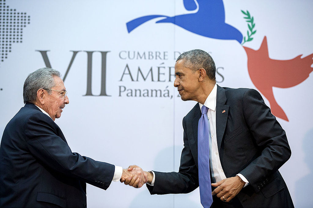 Caption: President Barack Obama and President Raúl Castro shake hands at the 7th Summit of the Americas. 2015. (Pete Souza/Wikimedia Commons)