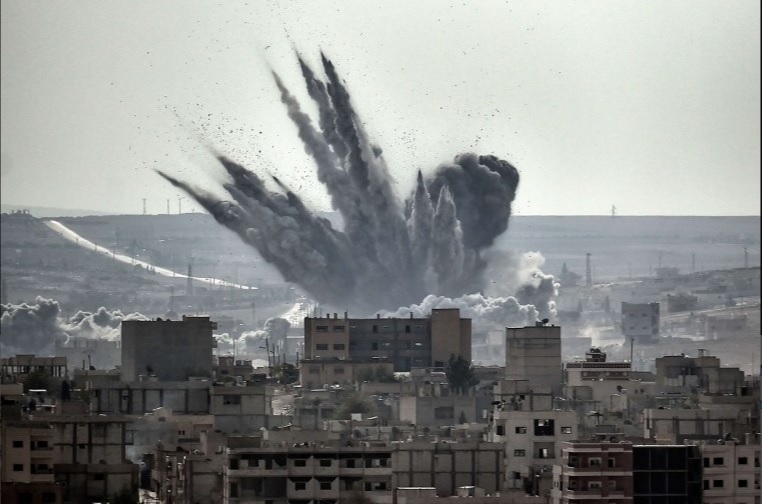 A shell explodes in the Syrian city of Kobane, also known as Ain al-Arab (Jordi Farrus/ Flickr Media Commons 2014)